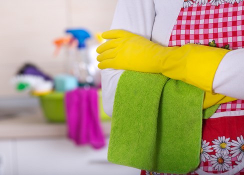 A manager inspecting a cleaned room while reviewing a complaint